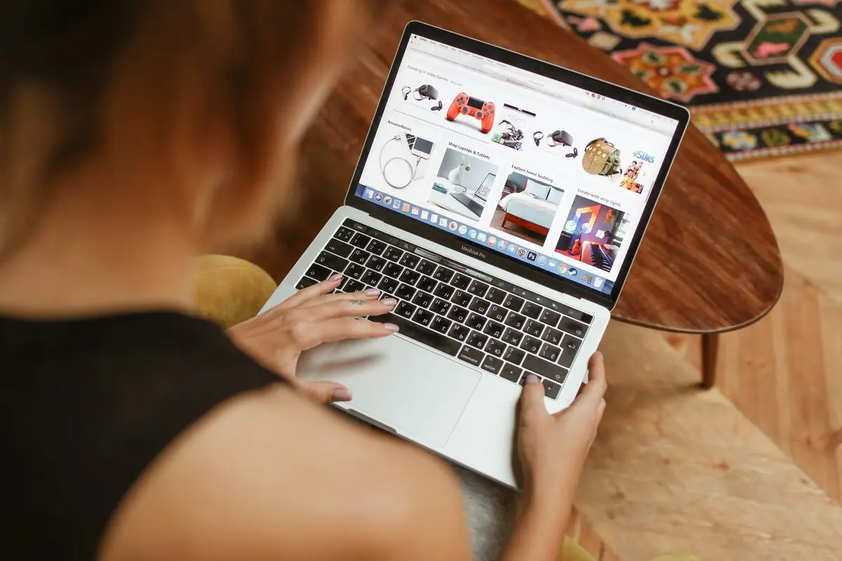 Woman working on laptop browsing ecommerce